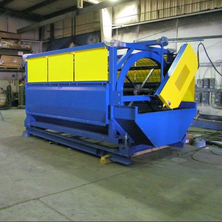 Blue and yellow Remcon trommel screen in the shop before delivery.